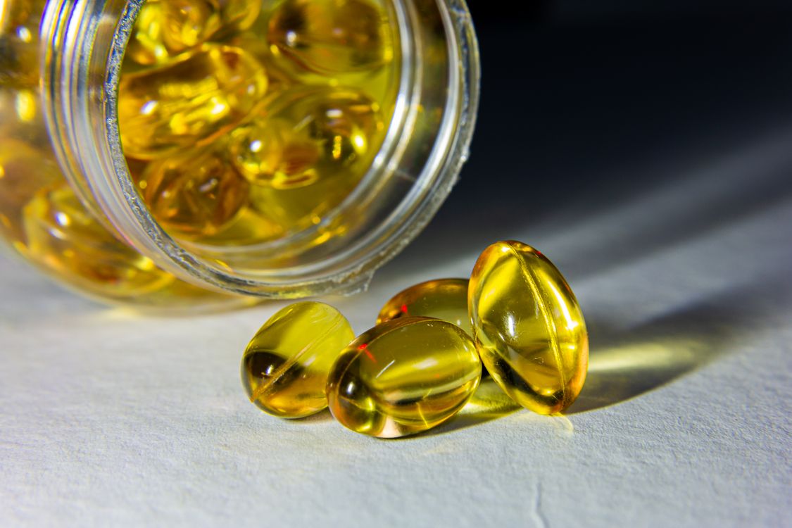 Golden softgel supplement capsules representing Cordyceps cardiovascular health research